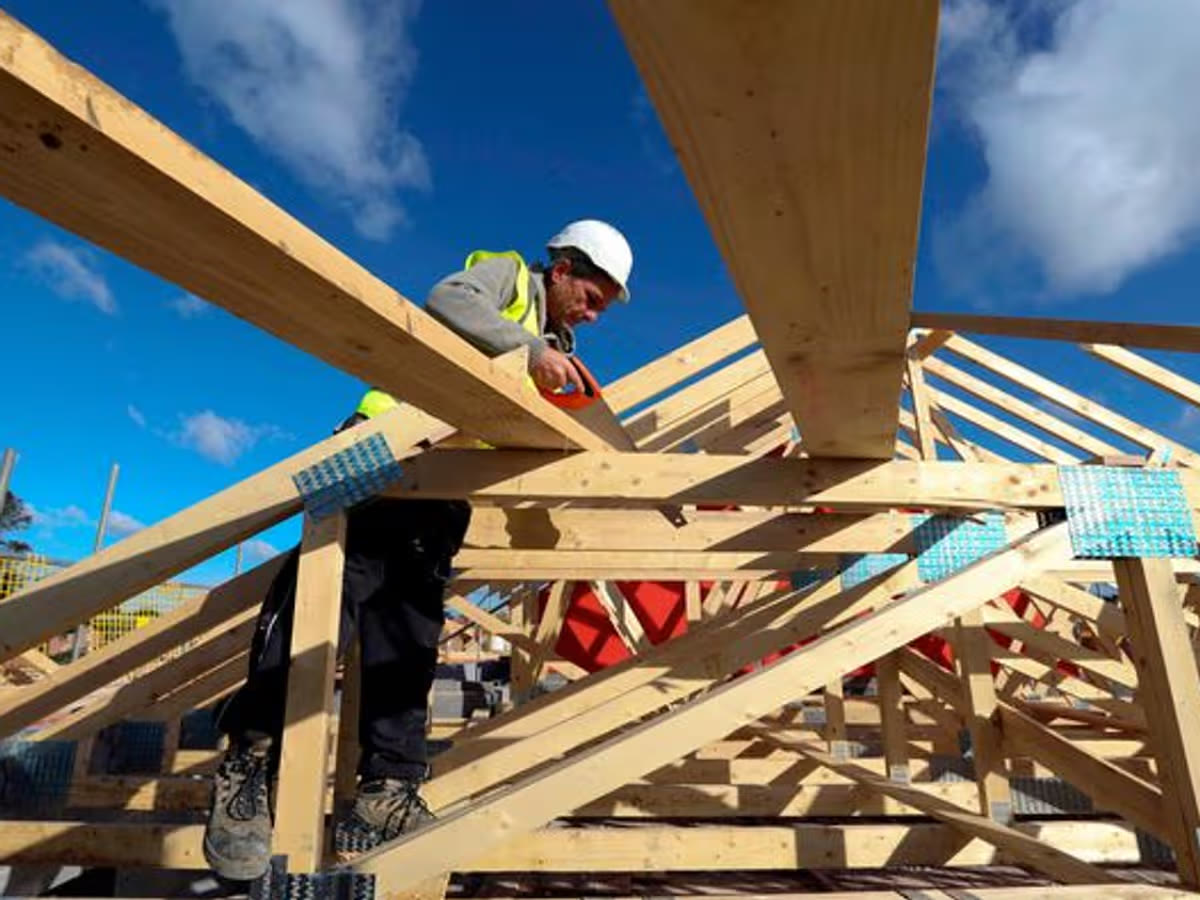 Belca Construction craftsman working on a timber frame